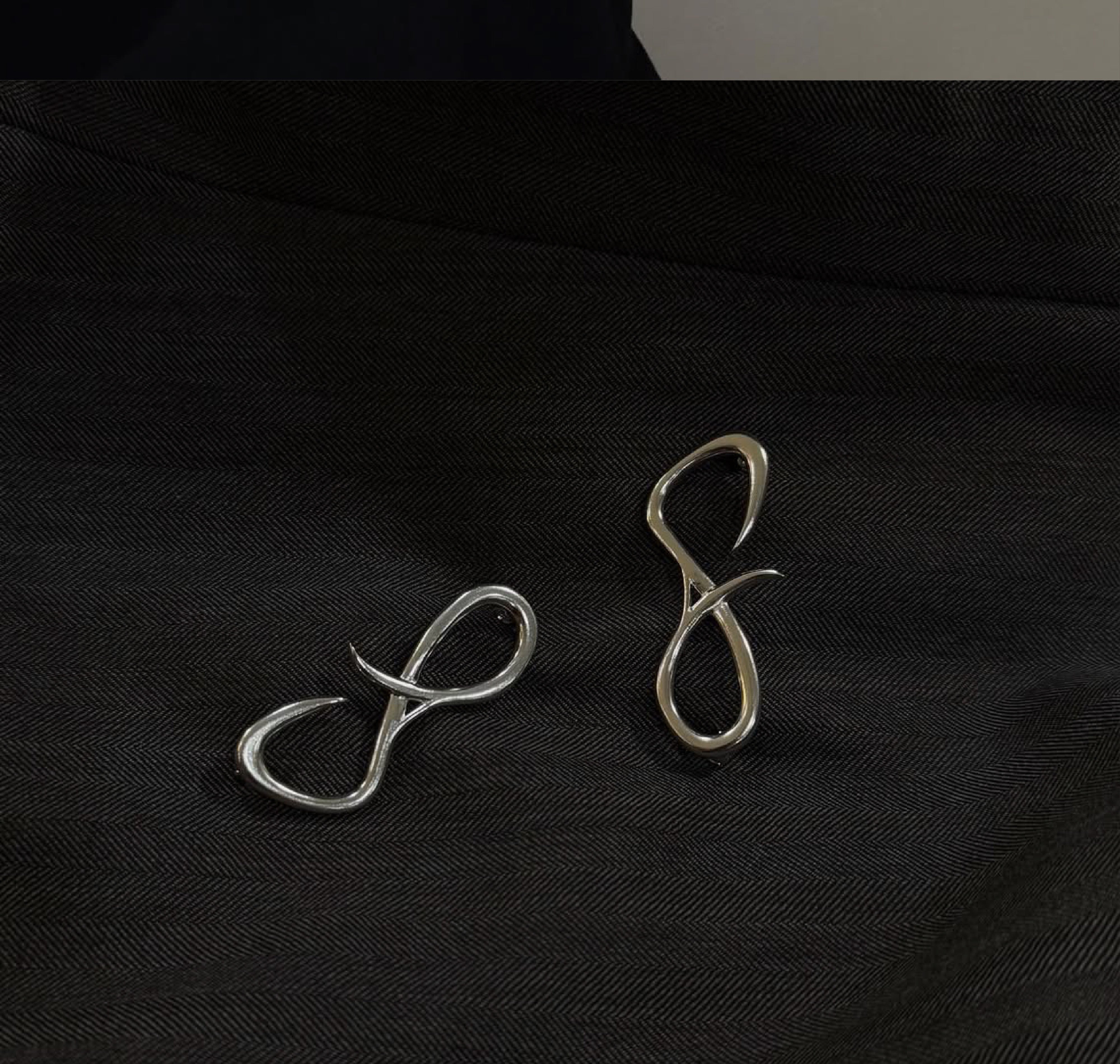 Bespoke metal forms on black fabric